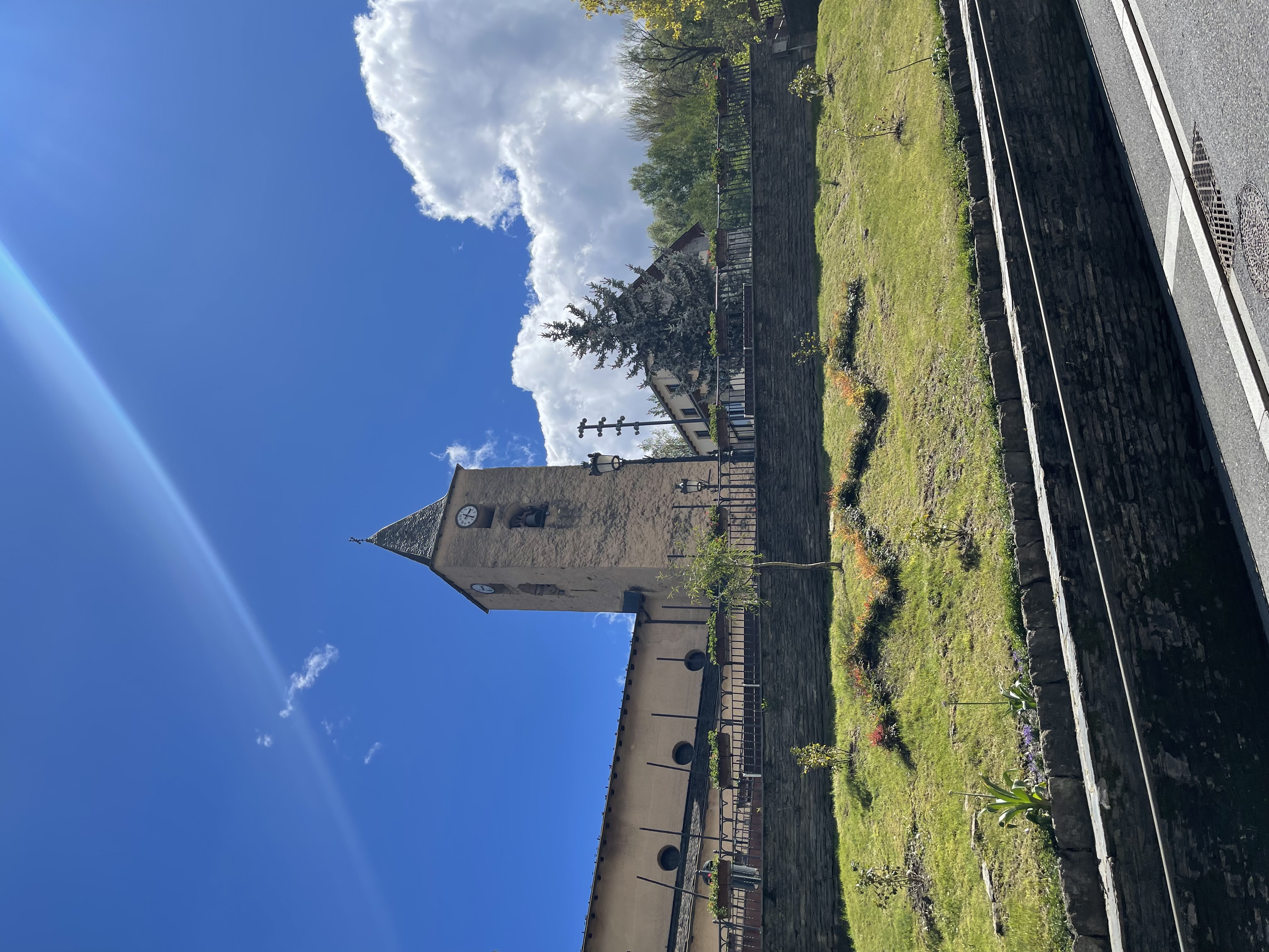The church and bell tower from the gardens, La Massana, sunny day